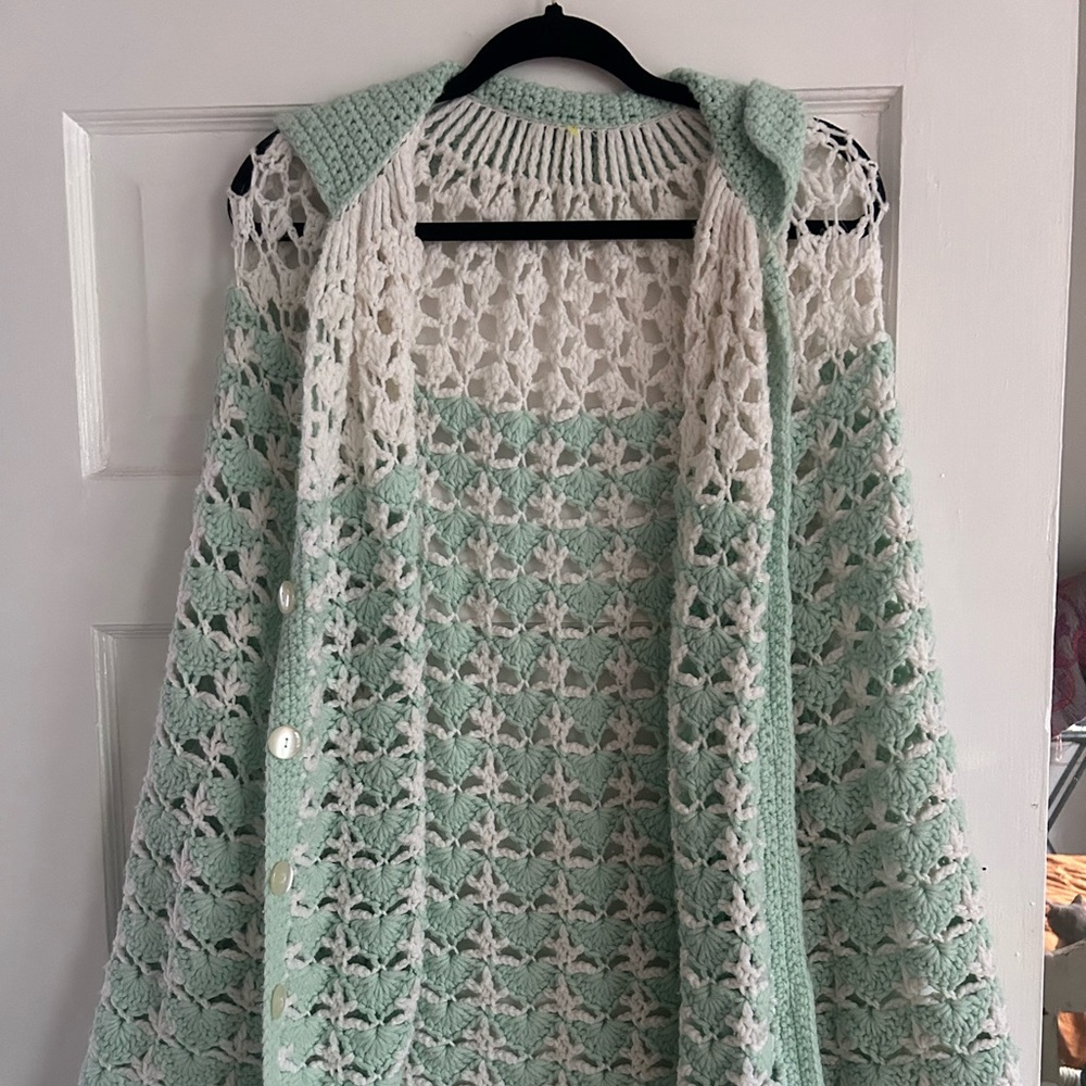Homemade green and white crochet poncho